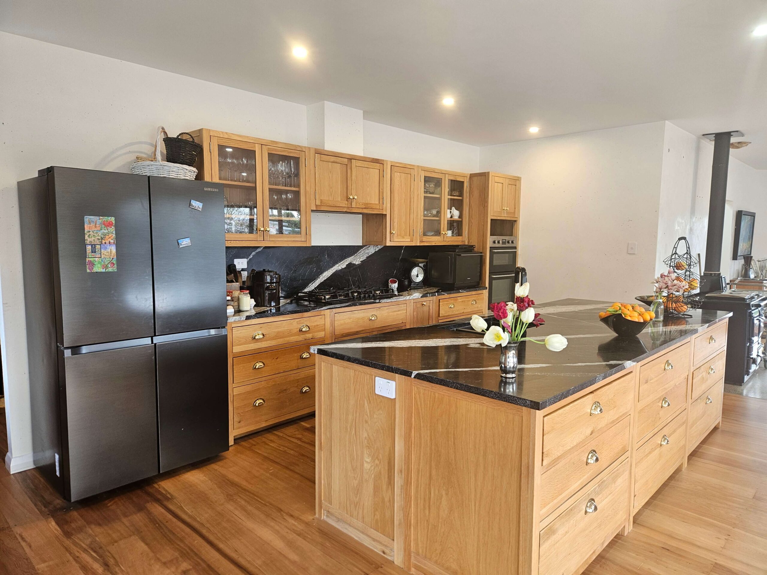 Open-plan kitchen renovation Waikato with stone benchtop by Ox Builders