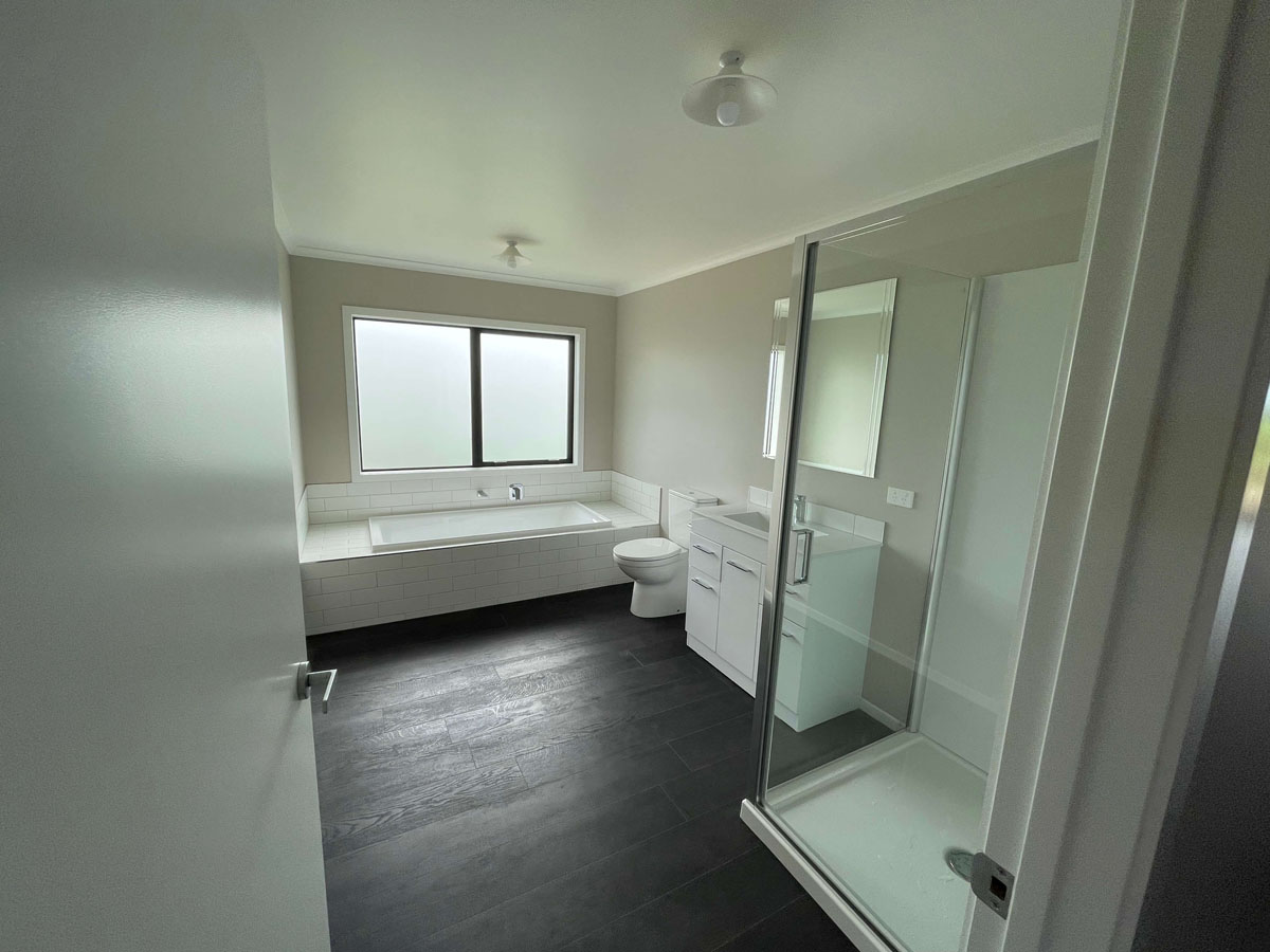 Modern tiled bathroom renovation completed by Ox Builders in Waikato